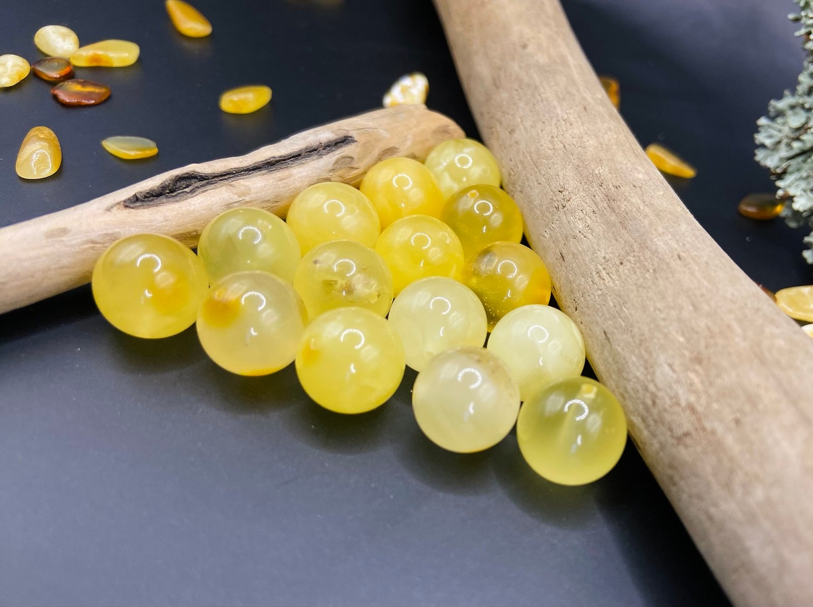 Perfect round butterscotch beads next to driftwood