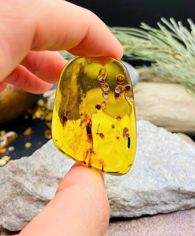 56548094-r-il-193e20-7266776535-il_794xN.7266776535_sqi2 Pulēti stikla tipa Dzintara akmeņi, katrs 7 grami smags