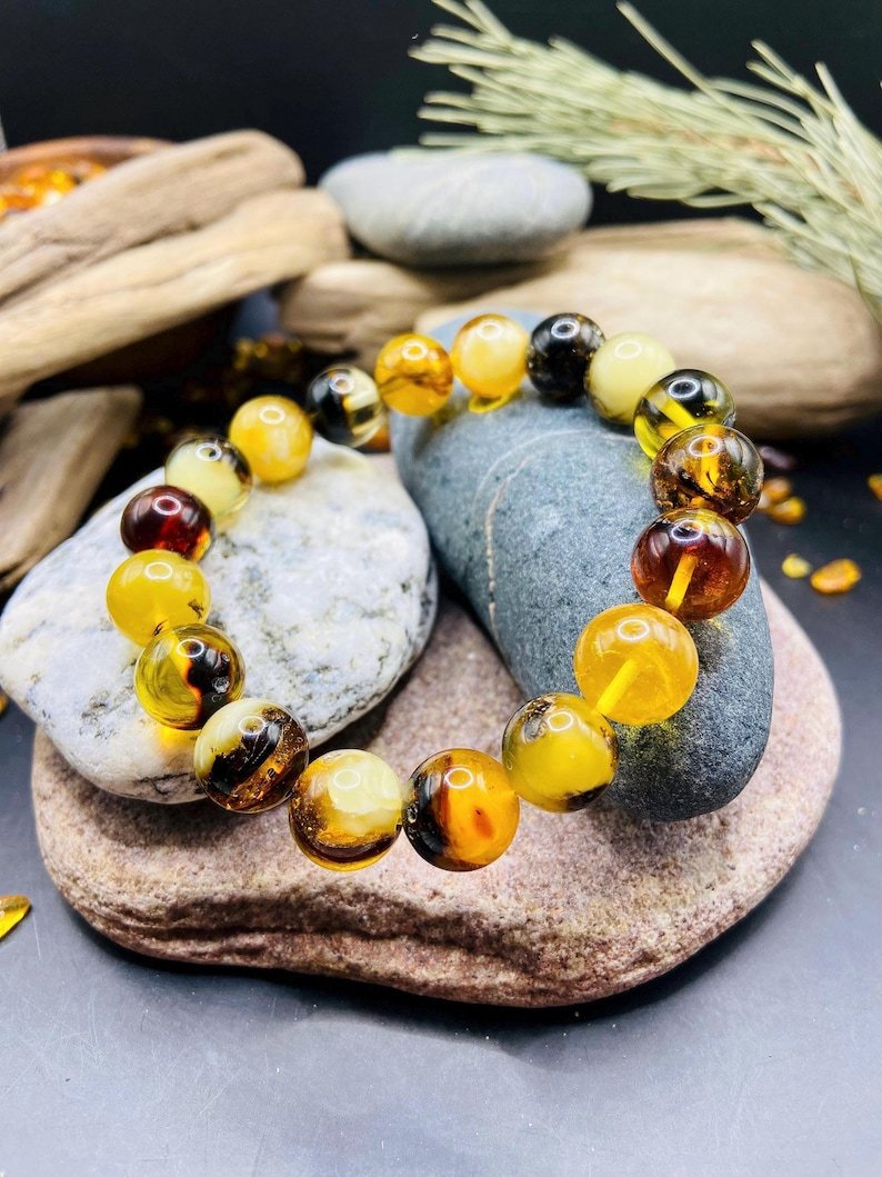 56548094-r-il-6b3d84-7319460239-il_794xN.7319460239_cj8w 11mm Daudzkrāsainu Dzintara pērlīšu aproce