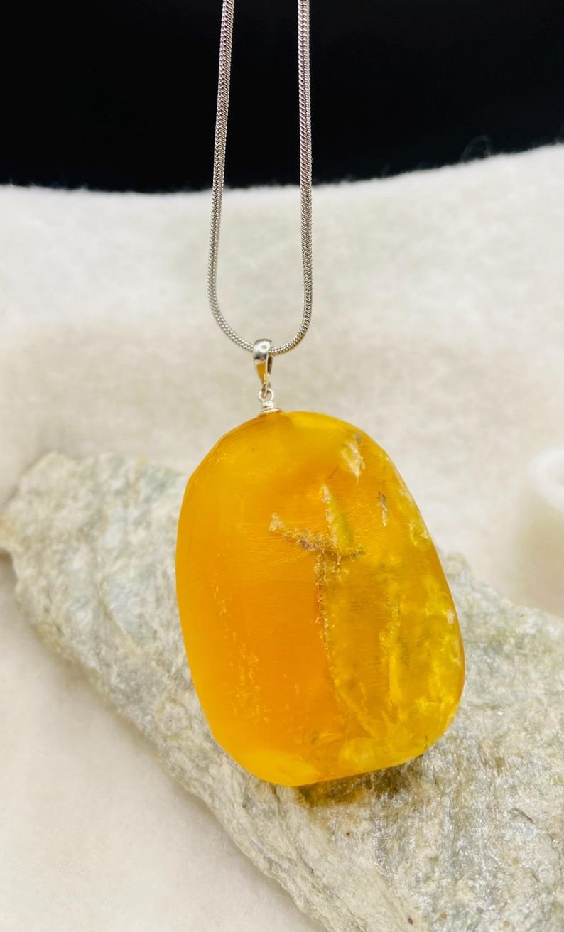 Milzīgs oranžas krāsas Dzintara kulons ar sudraba detaļu