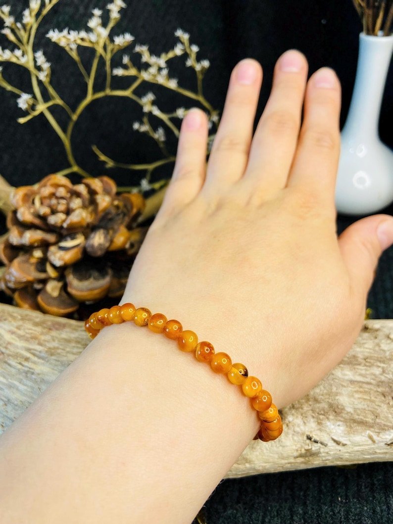 56548094-r-il-c55841-6788956090-il_794xN.6788956090_8srt Ugunīgā Baltijas Dzintara apaļo pērlīšu aproce